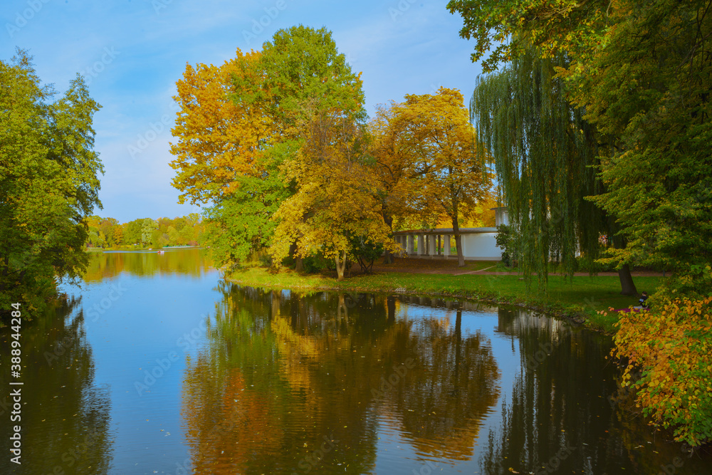 Castle pond in Chemnitz, Germany with beautiful fall season foliage reflected in its calm waters.
