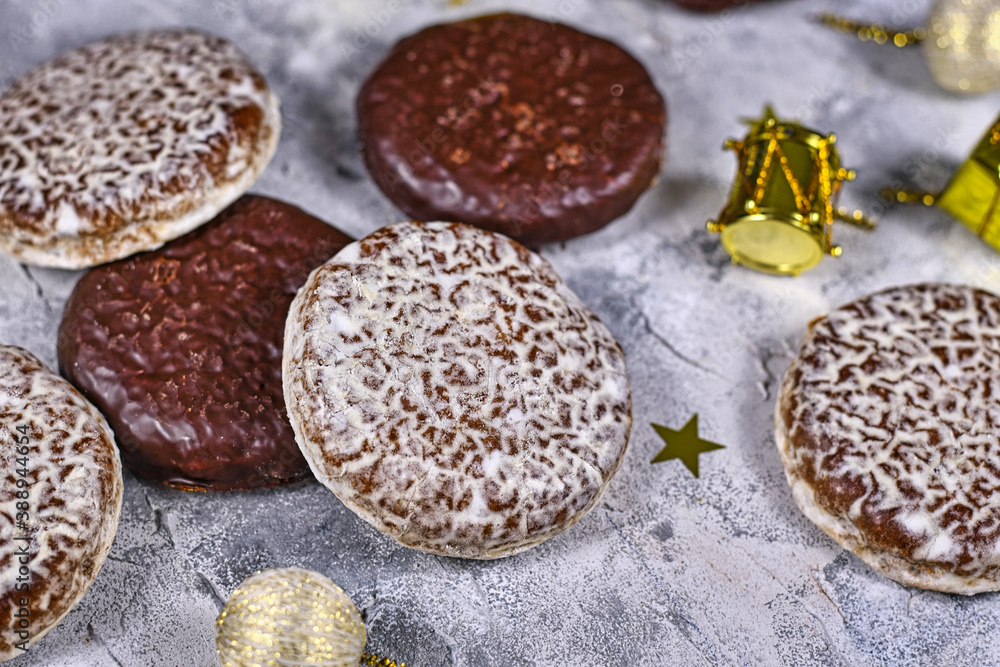 German round gingerbread called 'Lebkuchen' with white and chocolate glazing surrounded by seasonal Christmas decoration