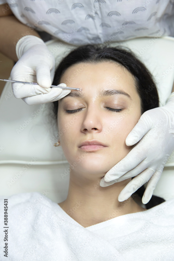 Blackhead cleansing on woman face during facial treatment at beauty