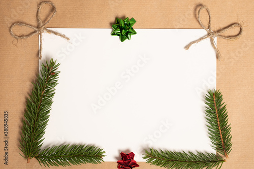 Christmas card with place for text. Gifts, fir tree branches, red decorations. Flat lay, top view, copy space.