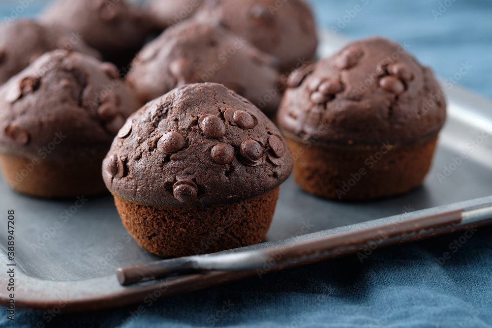 Chocolate muffins with chocolate drops on a dark background. Chocolate muffins with chocolate drops on a dark background.