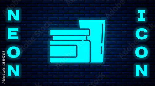 Glowing neon Baby food icon isolated on brick wall background. Vector.