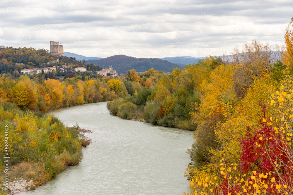 Donjon of the city of Crest with the Drôme river in foreground and autumn colors Donjon of the city of Crest with the Drôme river in foreground and autumn colors