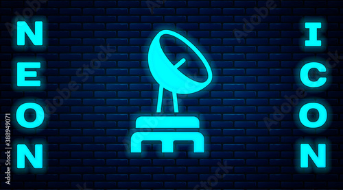 Glowing neon Radar icon isolated on brick wall background. Search system. Satellite sign. Vector.