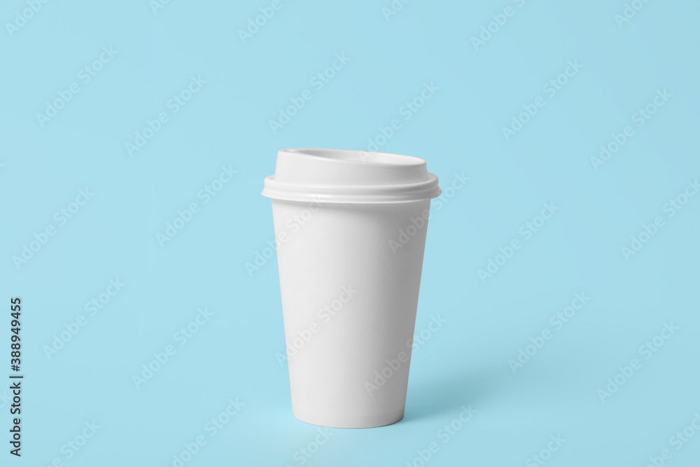 Takeaway paper coffee cup on light blue background Takeaway paper coffee cup on light blue background