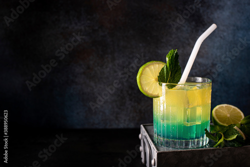 cocktail with orange juice and blue curacao liqueur in a glass photo