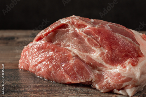 raw meat close-up. piece raw pork neck close-up. Pork tenderloin on a dark background
