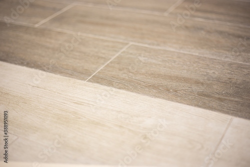 background of porcelain stoneware in two shades of light brown wood, blurred focus