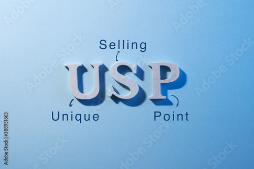close up of aphabet usp on blue background  -word unique selling point photo