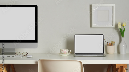 Worktable with computer, laptop, decorations and copy space in home office, clipping path © bongkarn