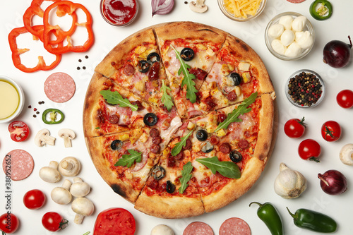 Pizza and ingredients on white background, top view