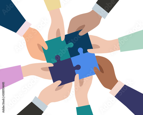 The hands of businessmen connect the pieces of puzzles into a single whole.