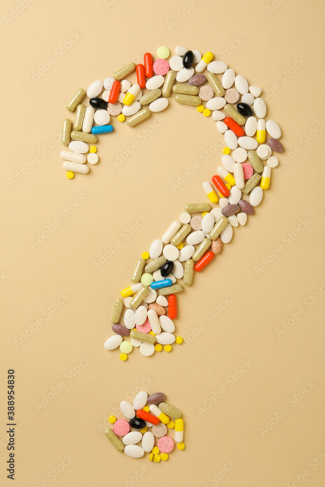 Question mark made of pills on beige background Question mark made of pills on beige background