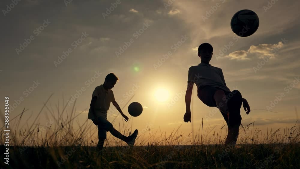 Happy child in the park plays with a soccer ball. Dream of childhood