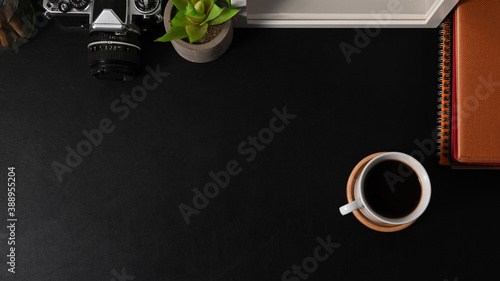 Workspace with coffee cup, camera, supplies, decorations and copy space