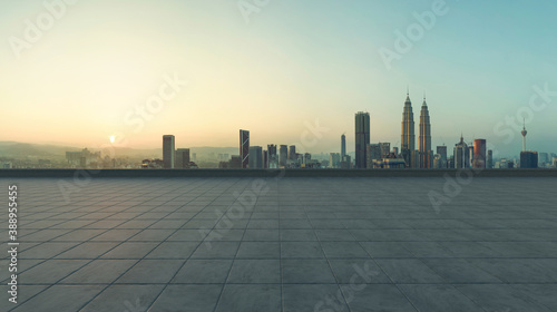 Empty concrete tiles floor with city skyline background