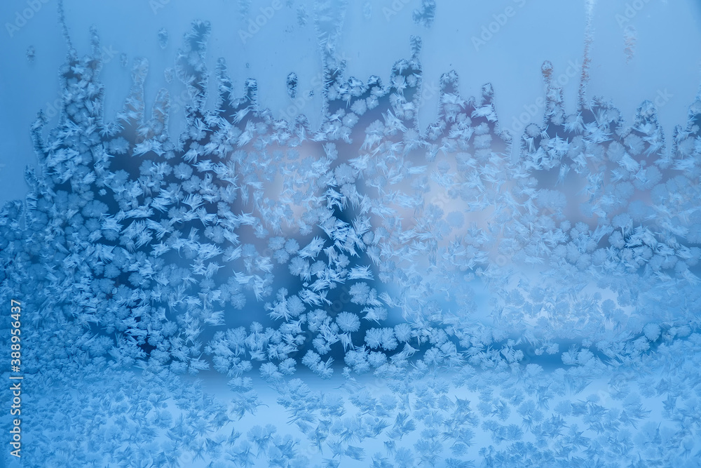 Blue ice frozen water natural background.  Photo of frost on the window. Frost pattern on glass. Abstract frost ornaments. Christmas background