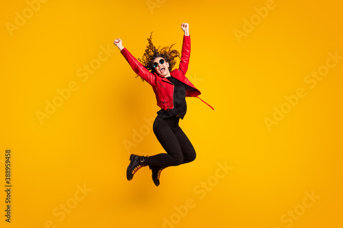 Full length body size view of attractive lucky cheerful wavy-haired girl jumping rejoicing victory isolated on bright yellow color background