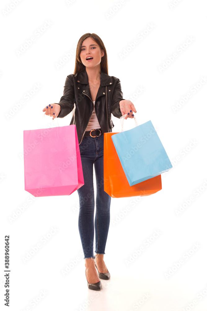 Beautiful girl with packages in her hands stands on a white background. Shopaholic with purchases in hand. Beautiful girl with packages in her hands stands on a white background. Shopaholic with purchases in hand.