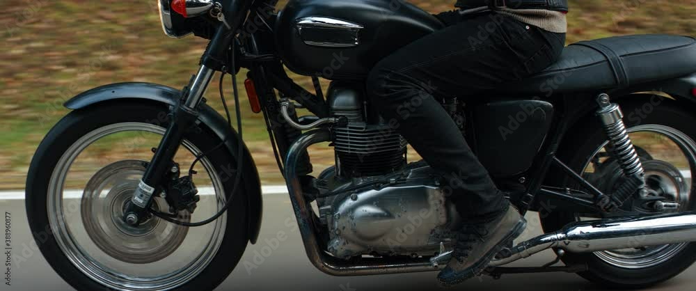 EXTREME CU TRACKING Biker riding his custom built vintage retro motorcycle on a scenic forest road. Shot on RED cinema camera with 2x Anamorphic lens EXTREME CU TRACKING Biker riding his custom built vintage retro motorcycle on a scenic forest road. Shot on RED cinema camera with 2x Anamorphic lens