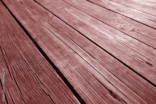 Old red wooden terrace floor close-up with blur effect.