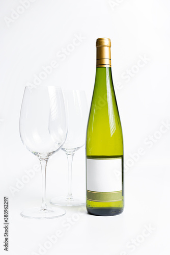 Bottle of White wine and empty glass.