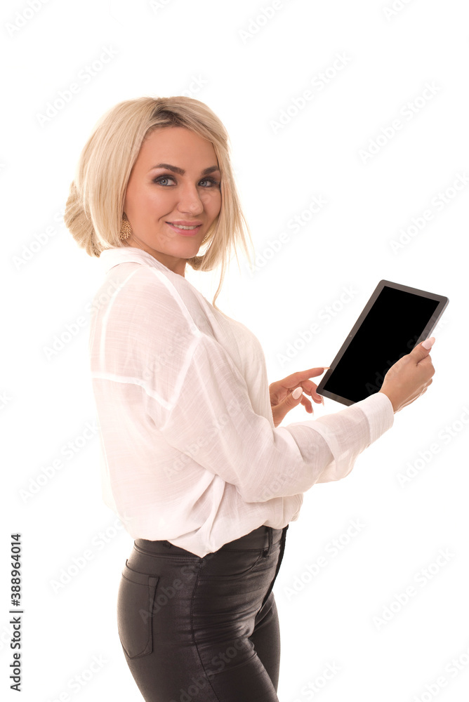 young girl looks at the camera while holding a tablet in her hands. Beautiful woman with tablet posing at camera. young girl looks at the camera while holding a tablet in her hands. Beautiful woman with tablet posing at camera.