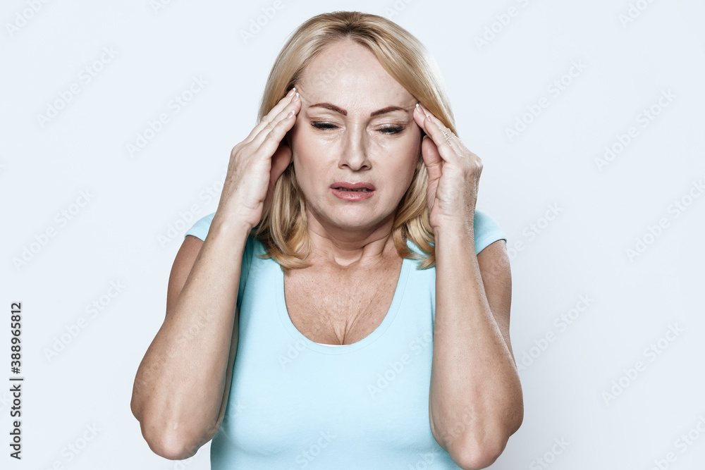 Girl holds hands on her head and feels a headache. Girl holds hands on her head and feels a headache.