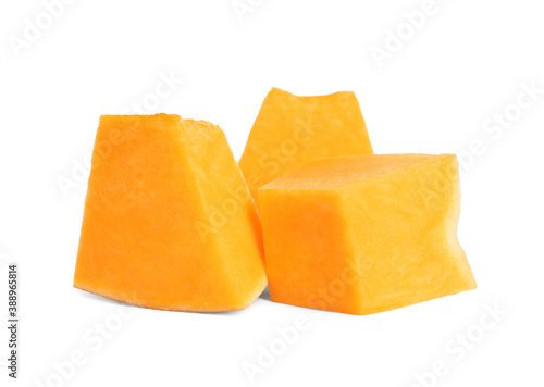 Pieces of ripe orange pumpkin on white background