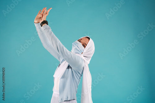 Young beautiful Asian woman wear protective face mask in prevention against Coronavirus epidemic isolated on blue background.