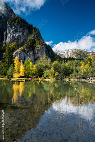 Fototapeta Naklejka Na Ścianę i Meble -  autumn forest at Lac de Derborence with reflection in Valais