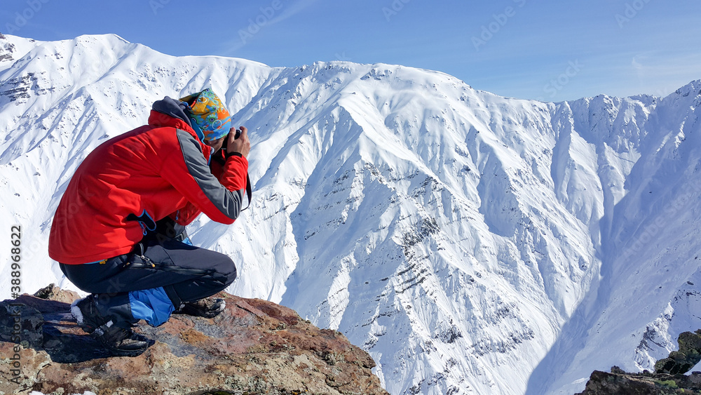 A skier, winter season, enjoying skiing, cold weather, white landscape
