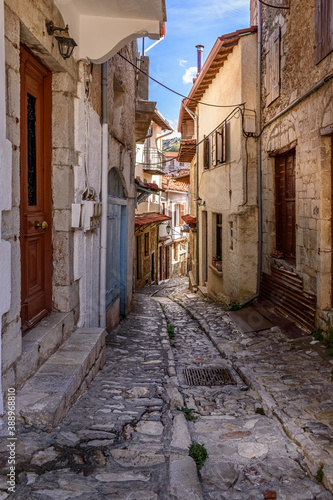 Traditional architecture in a narrow cobblestoned street in Dimitsana village, Greece.