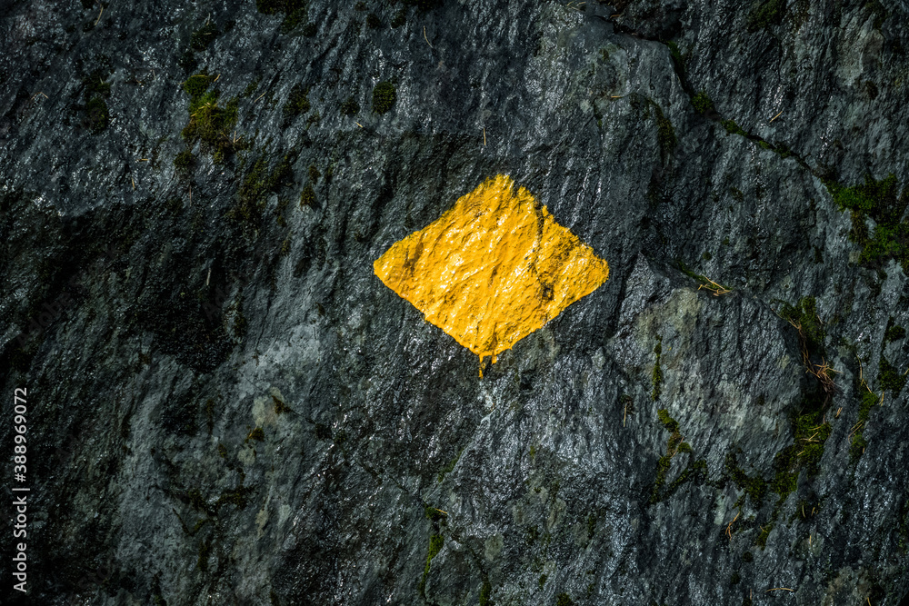 yellow swiss hiking trail sign