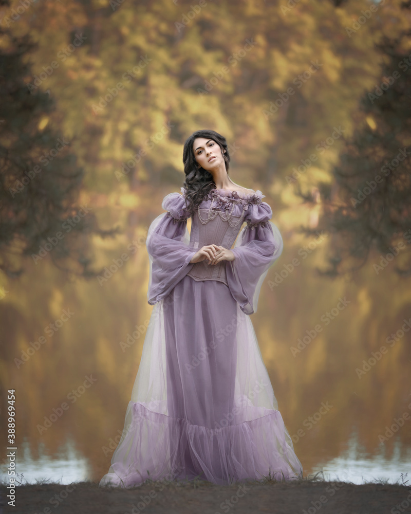 Graceful girl in a pink dress on the shore of an autumn lake Graceful girl in a pink dress on the shore of an autumn lake