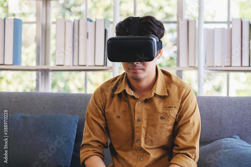 young man testing virtual reality technology at home