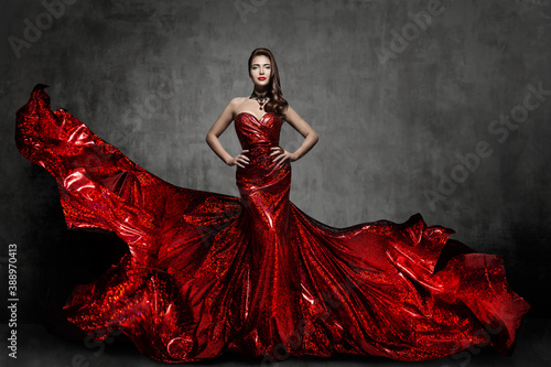 Woman Red Dress, Fashion Model in Long Silk Gown Waving Cloth on Wind, Flying Fluttering Fabric over Gray Background