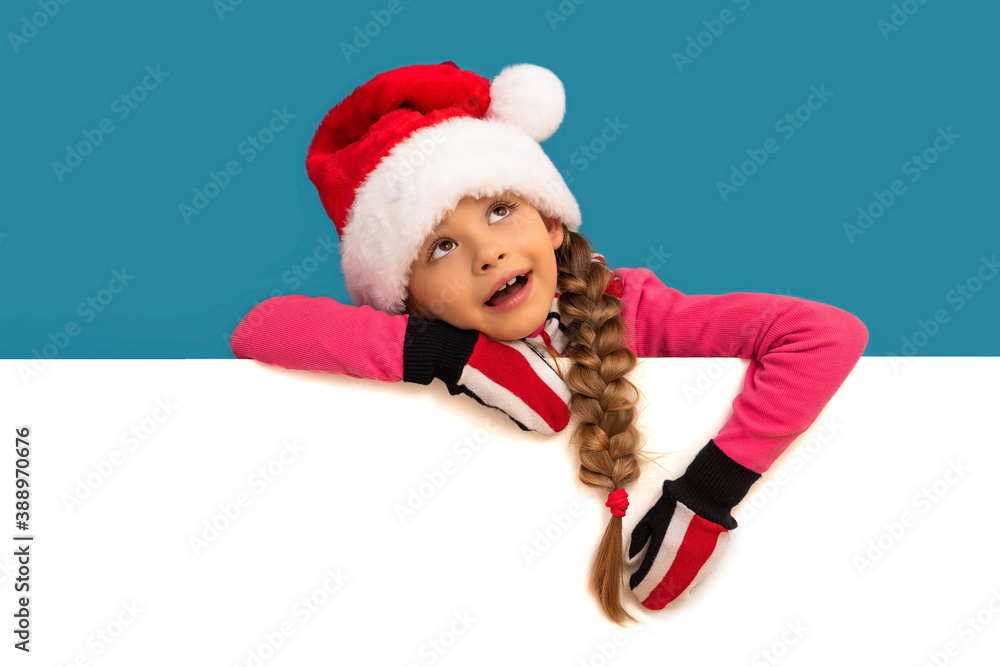 A little girl in a new year's hat leaned on the ad. A little girl in a new year's hat leaned on the ad.