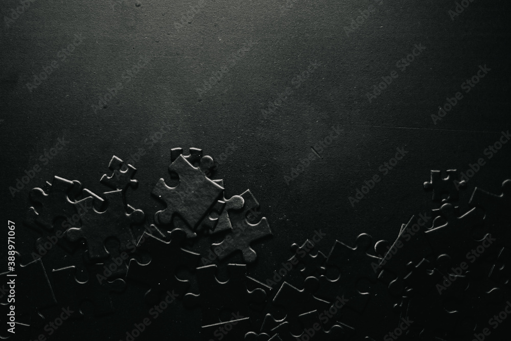 Photo of black puzzles on a black background, business background