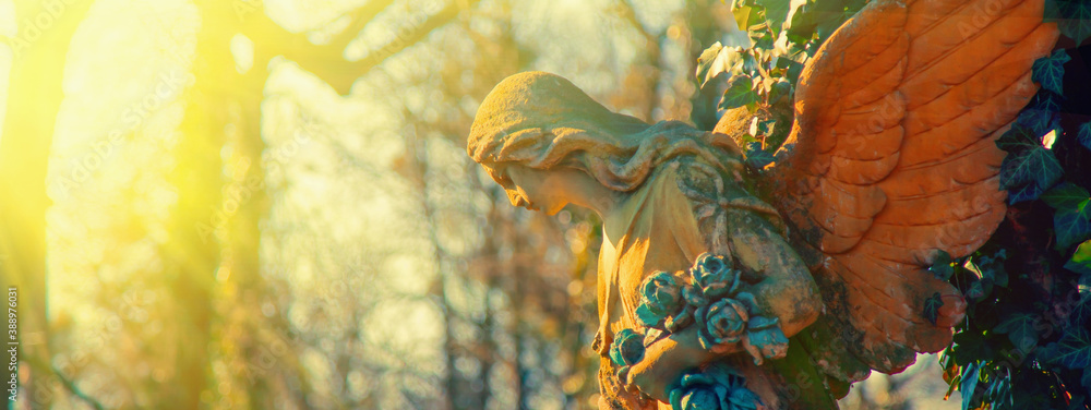 Antique statue of gold angel in rays of hope and sun. Metaphor image. Antique statue of gold angel in rays of hope and sun. Metaphor image.