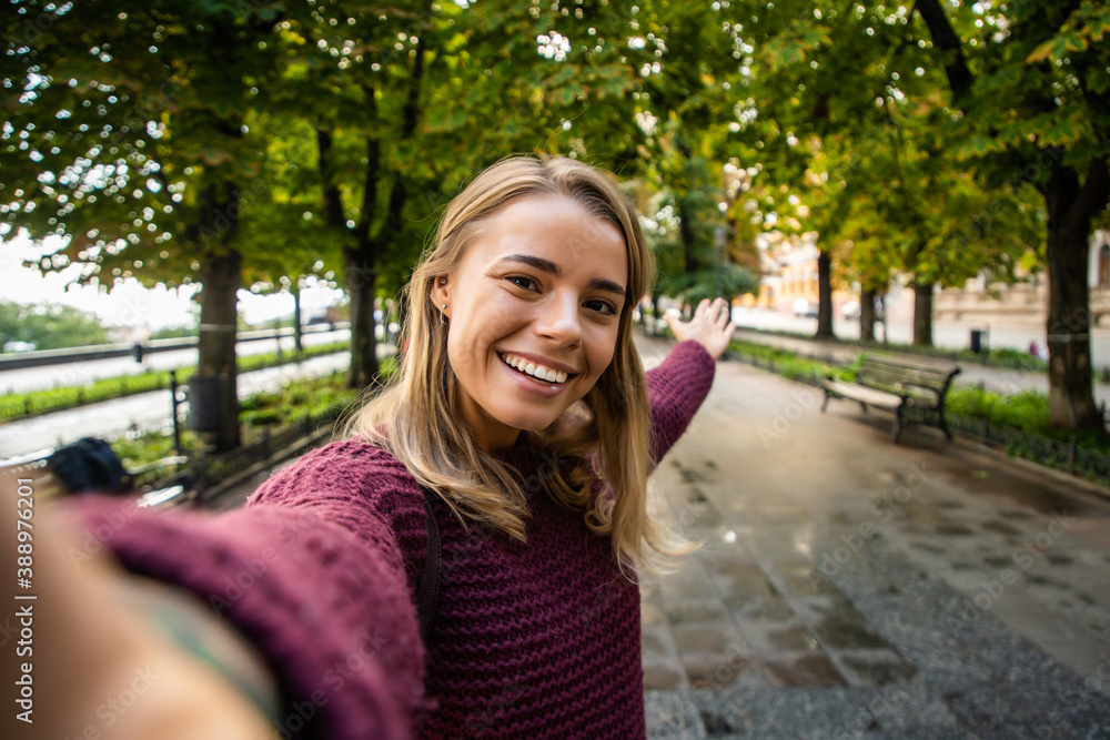 Young woman take selfie from hands with phone on summer city street. Young woman take selfie from hands with phone on summer city street.