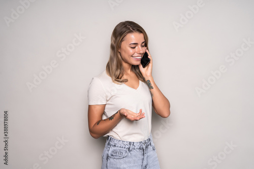 Happy woman talking on the phone isolated on white background