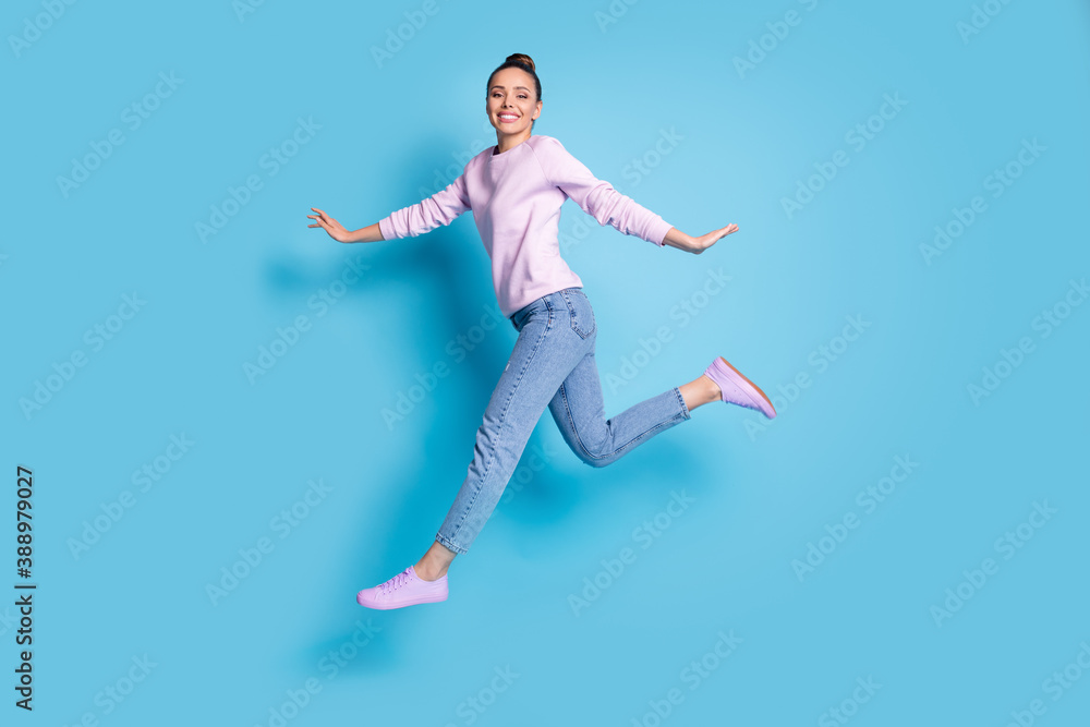 Full length body size profile side view of her she nice attractive pretty glad cheerful cheery girl jumping running enjoying free time isolated bright vivid shine vibrant blue color background