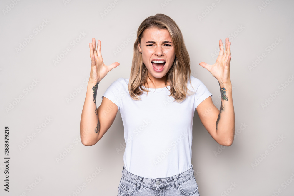 Young angry pretty woman screaming isolated on white background Young angry pretty woman screaming isolated on white background