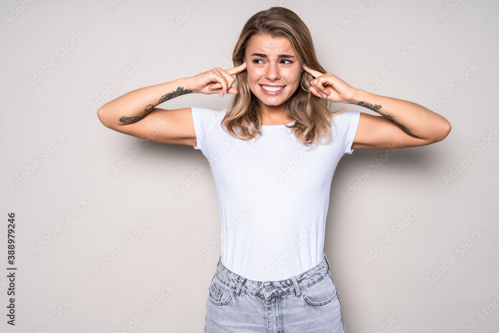 Sad young woman covering her ears isolated on white background Sad young woman covering her ears isolated on white background