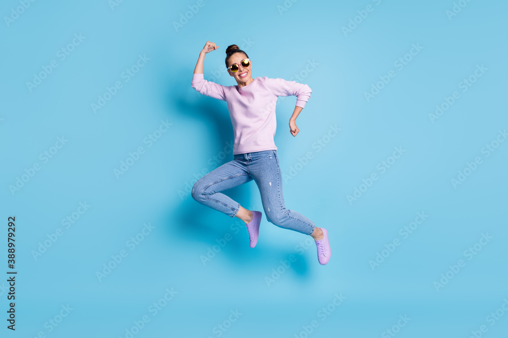 Full length photo of positive cheerful girl jump enjoy winter season discounts wear good look pullover footwear specs isolated over blue color background