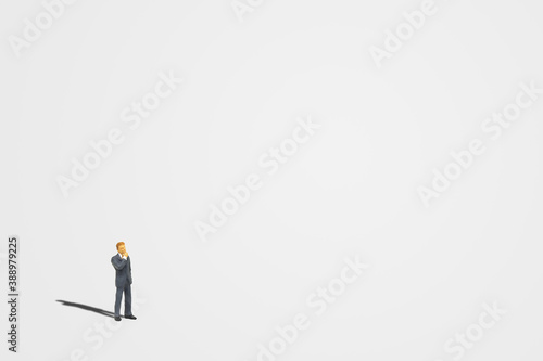 Konstfotografi Big Thinking Concept : Miniature people figure model as businessman standing and thinking on floor