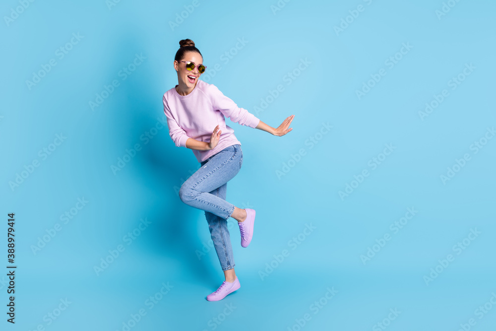 Full body photo of positive cheerful girl enjoy rejoice dance discotheque wear good look sweater sneakers specs isolated over blue color background