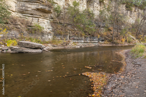 Fototapeta Naklejka Na Ścianę i Meble -  Root River In Autumn - A scenic river next to a cliff.