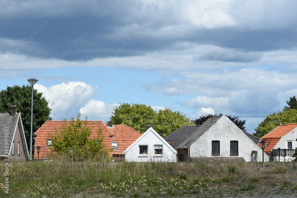 tiny houses behind dyke of river Rhine 
